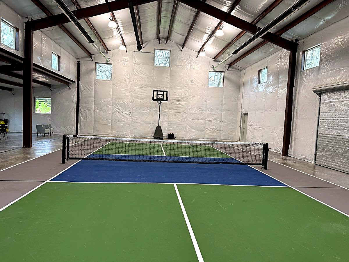 Indoor pickleball court painted green and blue