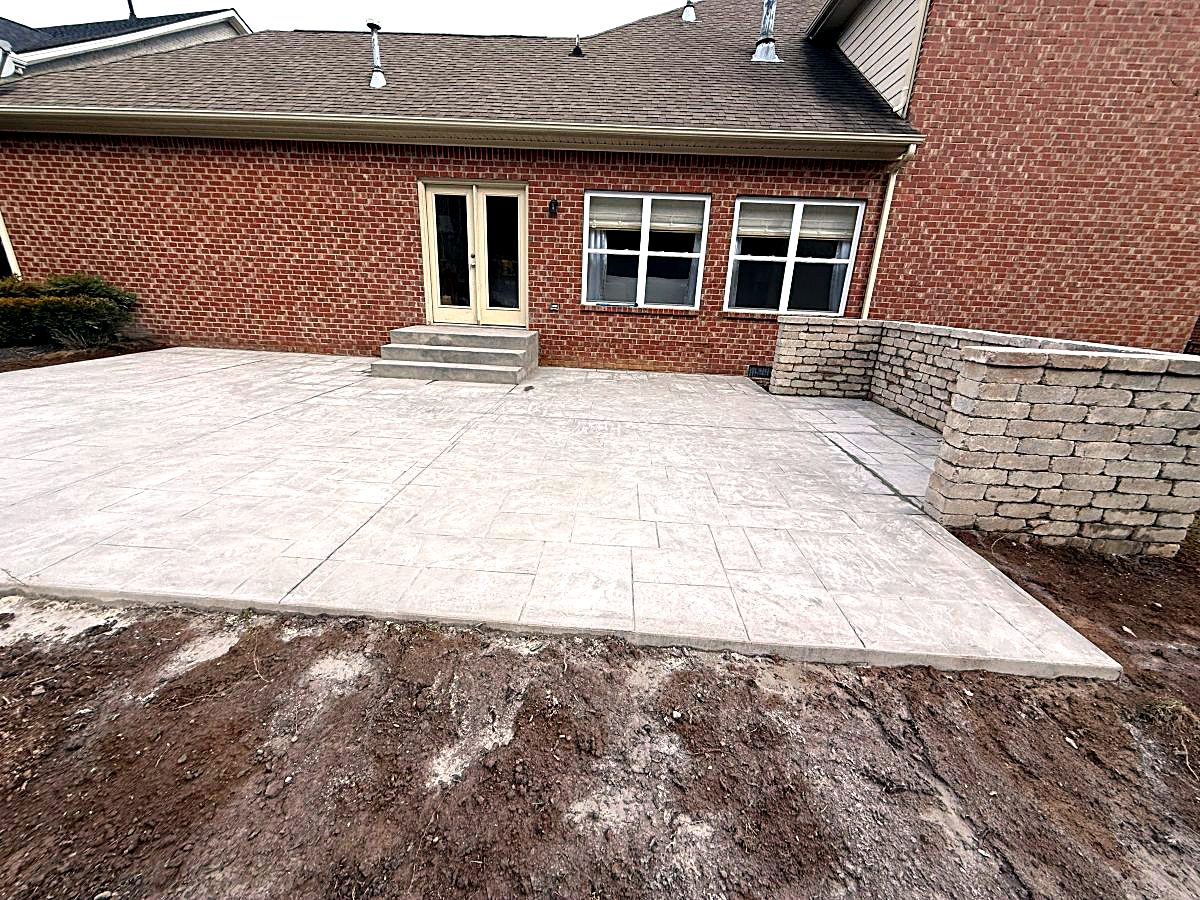 Stamped concrete patio and steps at a back door
